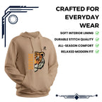 Man sitting on a stool wearing a beige Rovarix hoodie , in a studio setting with lighting equipment.