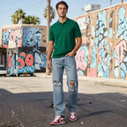 Man wearing Rovarix relaxed fit distressed light wash jeans walking in urban street