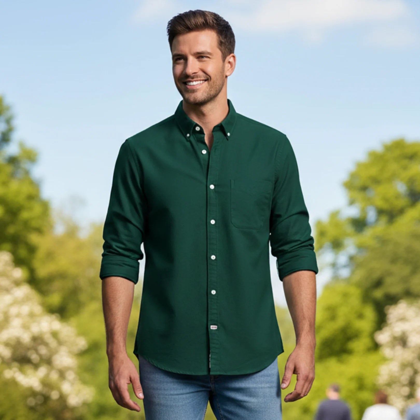 Man wearing Rovarix forest green Oxford button-down shirt with rolled sleeves 