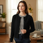 Woman wearing Rovarix black button-front cardigan over gray tee in cozy home interior