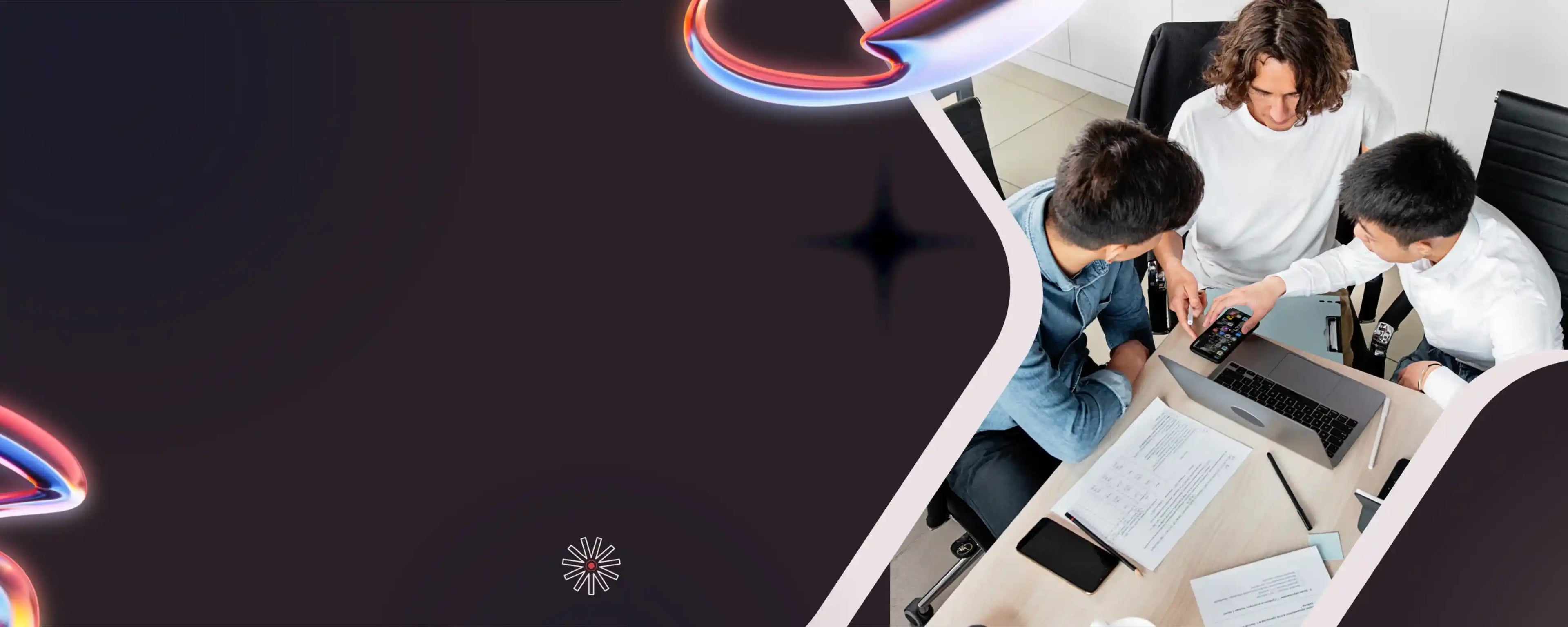 Two people working on a laptop at a desk with colorful abstract elements.