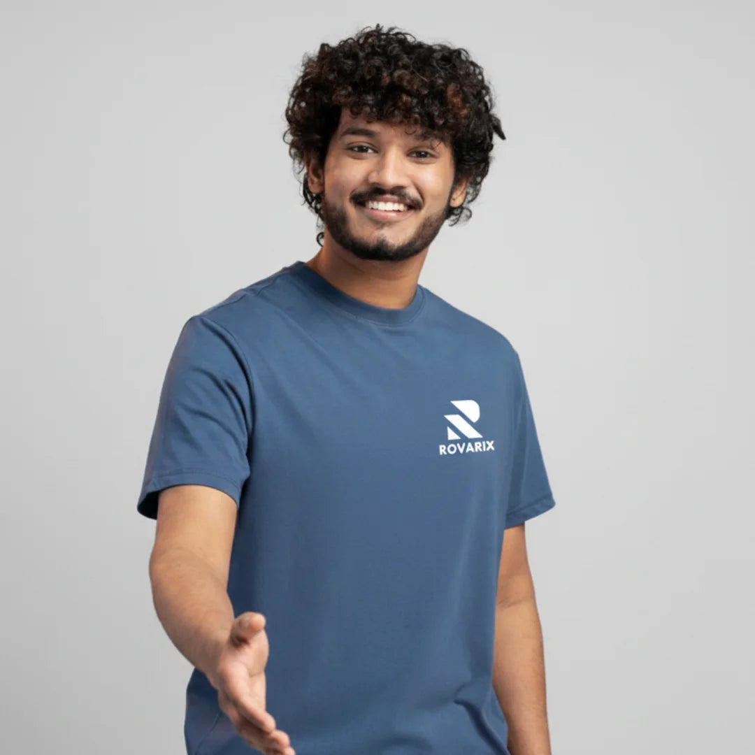 Man wearing a blue t-shirt with Rovarix logo on a gray background