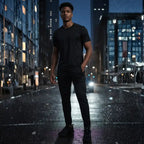 thletic man wearing Rovarix all-black athletic trousers and black performance athletic shirt 