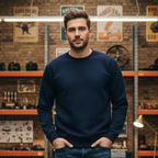 Man wearing Rovarix navy blue crewneck sweatshirt loungewear standing in vintage garage