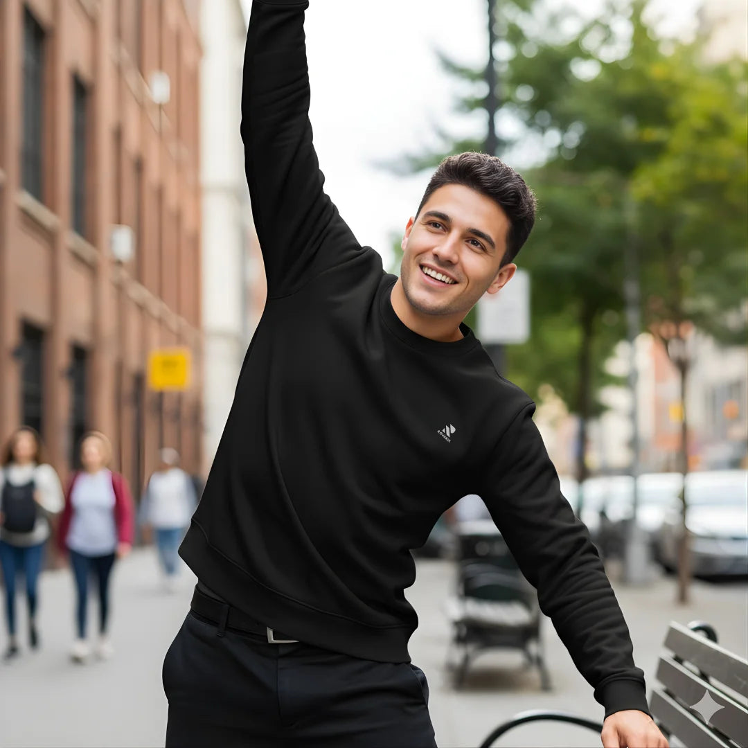 Man in black outfit raising his arm on a city street