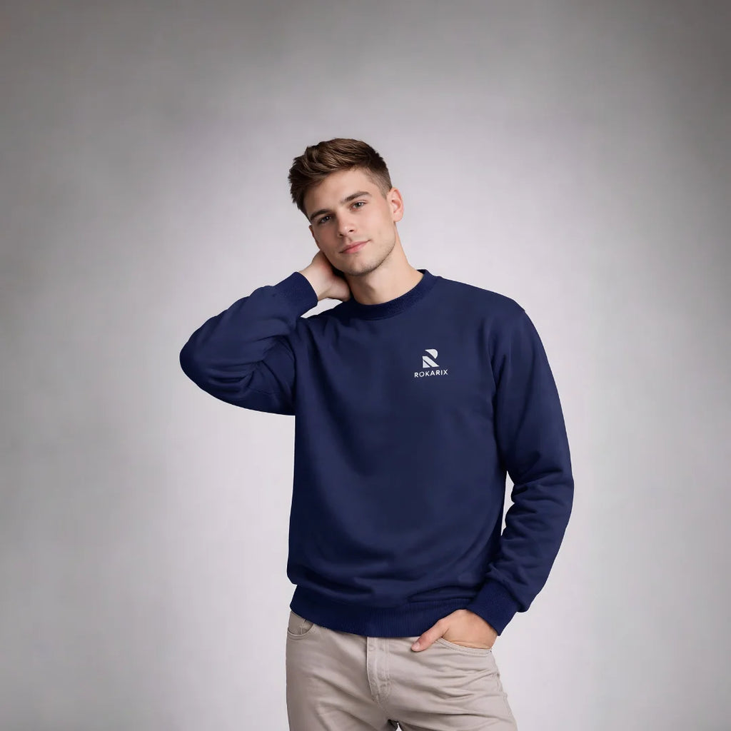Man wearing a Rovarix navy blue sweatshirt with a logo on a gray background