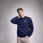 Man wearing a Rovarix navy blue sweatshirt with a logo on a gray background