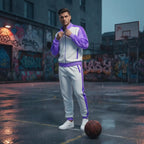 Man wearing Rovarix white and purple retro tracksuit on basketball court in urban setting