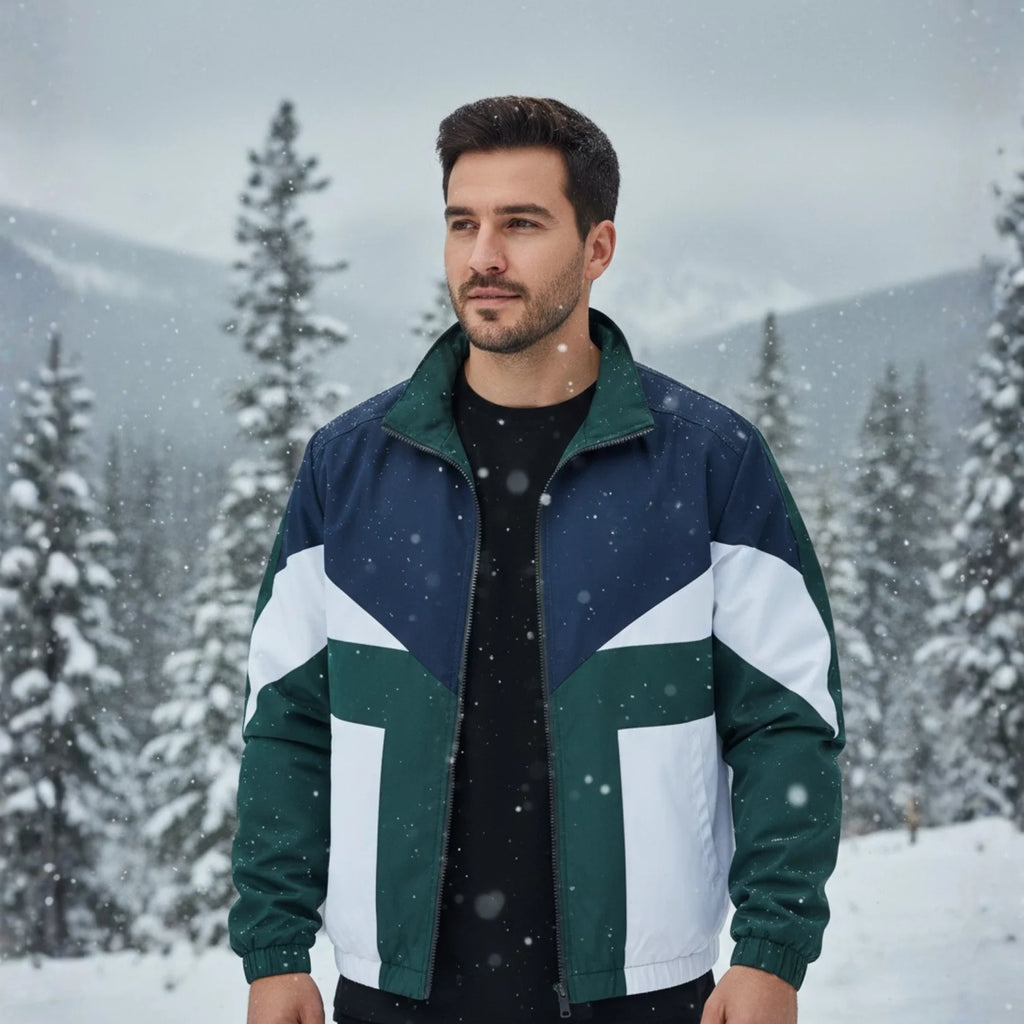 Man wearing Rovarix retro color-block windbreaker jacket in navy, green, and white walking outdoors