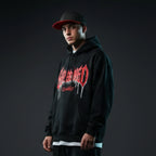 Young man wearing Rovarix black and red snapback hat with flat brim and streetwear hoodie