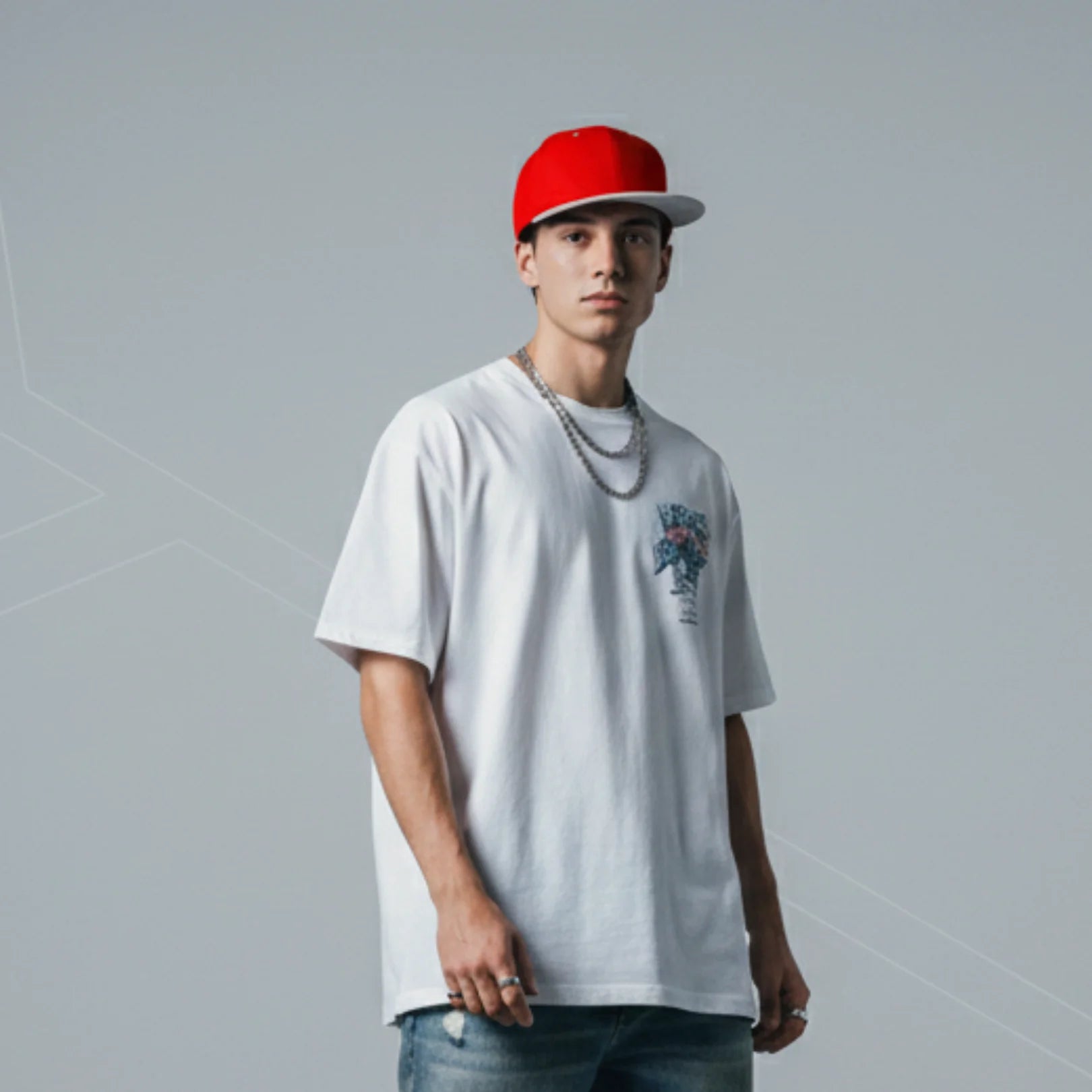 Young man wearing Rovarix red and white snapback hat with flat brim and streetwear outfit