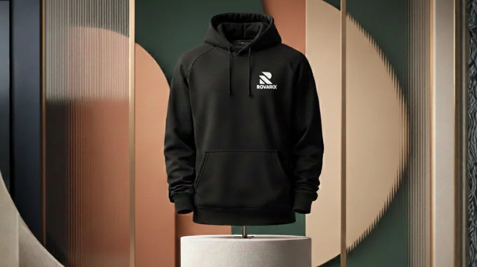 Black hoodie with a logo on a mannequin against a decorative wall.