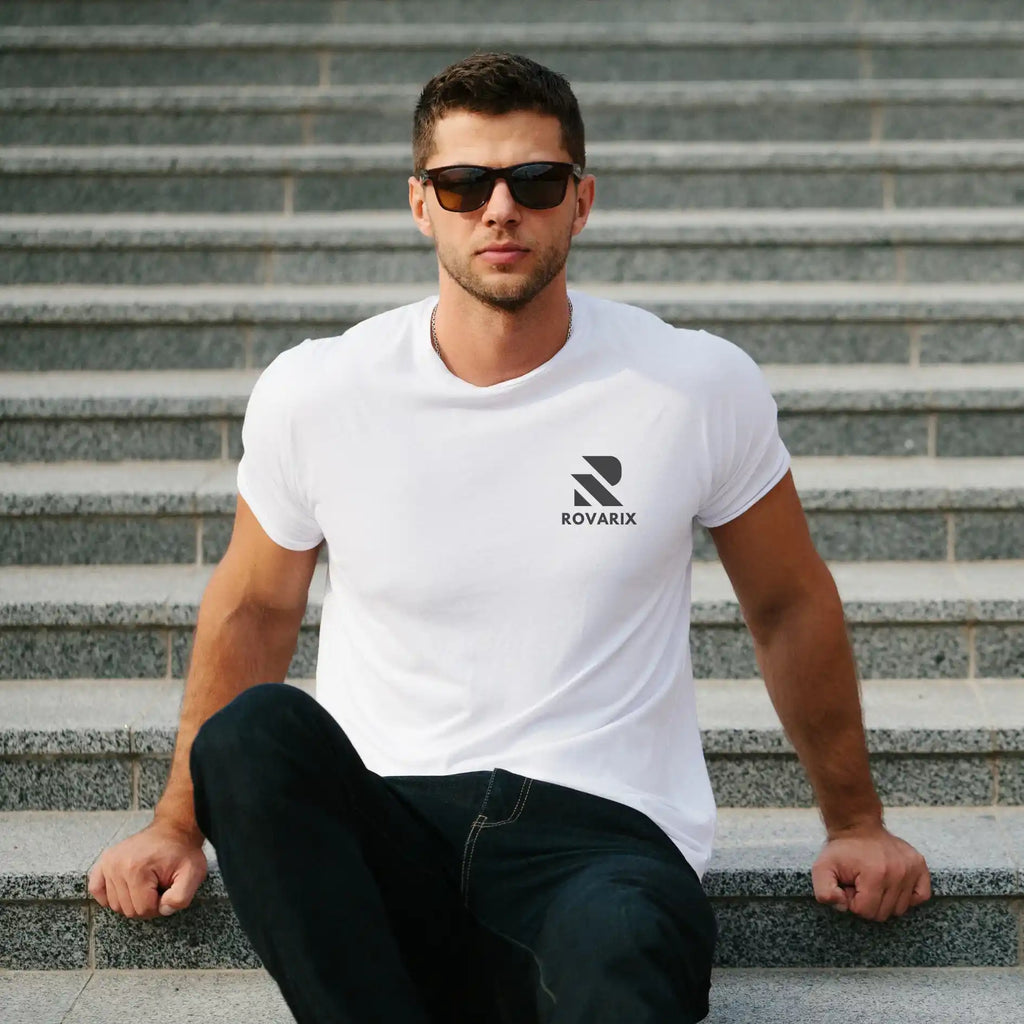 Man wearing a white t-shirt with a logo sitting on steps