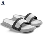 Rovarix white slide sandals with black geometric pattern straps and cushioned massage footbed