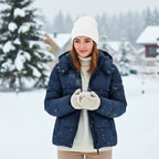 Woman wearing Rovarix white knit winter beanie in snowy outdoor winter scene with navy jacket